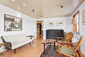 a living room with a couch and a table at 20328-Samso-Besservej-35 in Tranebjerg