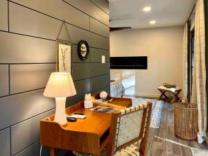 a room with a desk and a lamp on a table at Gwen's Cottage at Water's Edge in Portersville
