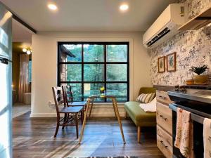 a kitchen and dining room with a table and a window at Gwen's Cottage at Water's Edge in Portersville
