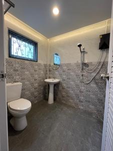 a bathroom with a toilet and a sink and a shower at Saen Saran property in Sathani Bang Ramat +15 photos
