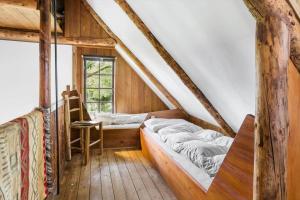 a attic room with a bed and a window at 20141-Samso-Ballebjergvejen-9 in Nordby
