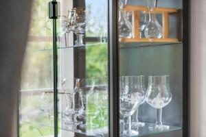 a bunch of wine glasses sitting on a shelf at 20329-Samso-Smedegade-8 in Tranebjerg +26 photos