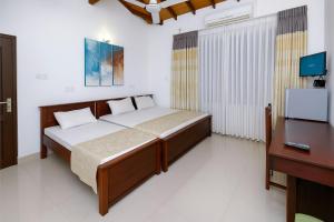 Ένα ή περισσότερα κρεβάτια σε δωμάτιο στο Ranaya Residence Kandy +31 φωτογραφίες