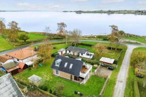 an aerial view of a house next to a lake at AE285-Aeroskobing-Hanses-Ager-4 in Ærøskøbing +19 photos