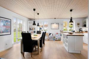 a kitchen and dining room with a table and chairs at AE285-Aeroskobing-Hanses-Ager-4 in Ærøskøbing