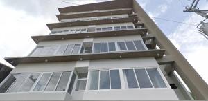 a tall white building with many windows at Lheaf Residences and Serviced Apartments in Cebu City