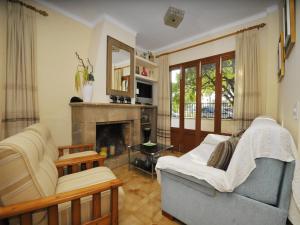 a living room with a couch and a fireplace at Terraced House Alcudia near Beach in Port d'Alcudia
