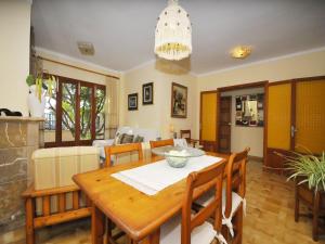 a dining room and living room with a table and chairs at Terraced House Alcudia near Beach in Port d'Alcudia +14 photos