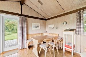 a dining room with a table and chairs at SB50361-Nordborg-Krabbestien-11 in Nordborg