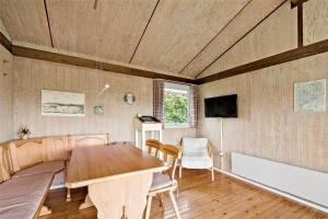 a dining room with a table and a tv at SB50361-Nordborg-Krabbestien-11 in Nordborg