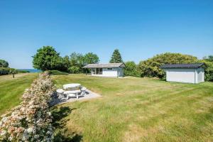 a picnic table in a field with a building at SB50361-Nordborg-Krabbestien-11 in Nordborg +11 photos