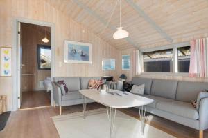 a living room with a couch and a table at SB113-Sydals-Oddermosen-11 in Sønderby