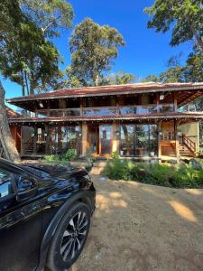 a car parked in front of a house at Mộc Thiên Xanh homestay in Kon Plong