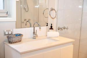 a bathroom with a sink and a shower at Twelve Apostles Beach House-STUDIO in Port Campbell