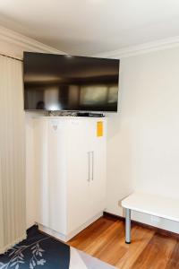 a kitchen with a white cabinet and a table at Twelve Apostles Beach House-STUDIO in Port Campbell
