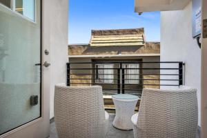 two chairs and a table on a balcony at Chic Modern Loft in Hollywood 1 Bedroom with Balcony & Free Secure Parking in Los Angeles