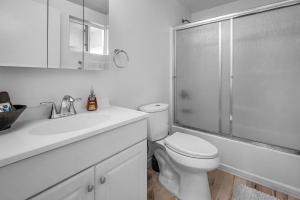 a white bathroom with a toilet and a shower at Chic Modern Loft in Hollywood 1 Bedroom with Balcony & Free Secure Parking in Los Angeles +8 photos