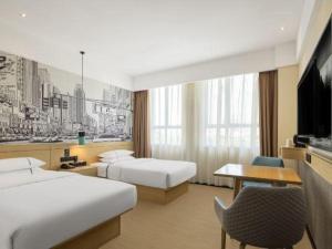 a hotel room with two beds and a desk at City Comfort Inn Liuzhou Gubu Street Ma'anshan Park in Liuzhou +146 photos