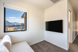 a living room with a couch and a window at Mountains on Clearview in Motungarara