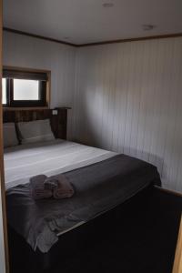 a bedroom with a bed with a towel on it at Mount Rumney Escapes - 5 Seaview Kangaroo House in Mount Rumney