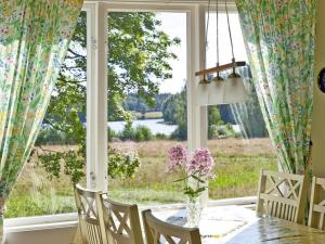 a dining room with a table and a large window at 4 star holiday home in Brålanda in Brålanda