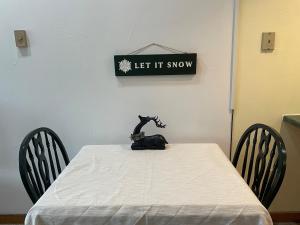 a table with a cat sitting on top of it at Cozy Downtown Hunter Mountain Getaway in Hunter