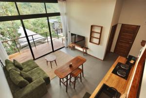 a living room with a couch and a table at Yume17 in Chaloklum