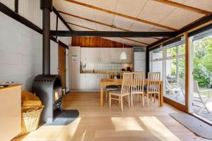 a kitchen and dining room with a wood stove at SB121-Sydals-Osterbyvej-21 in Østerby