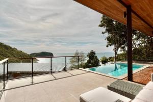 a view from the balcony of a house with a swimming pool at Yume17 - Sea View Villas in Chaloklum