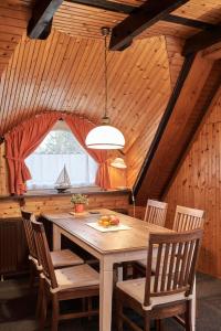 a dining room with a wooden table and chairs at Dünengras in Cuxhaven