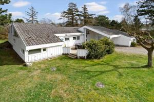 a large white house with a yard at 20128-Samso-Maarup-Osterstrand-60 in Nordby