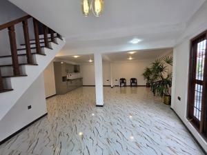 a large room with a staircase and a room with a floor at Saran villa in Kochchikade