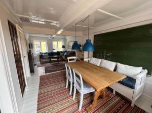 a dining room with a table and a couch at AE261-Aeroskobing-Sondergade-50 in Ærøskøbing