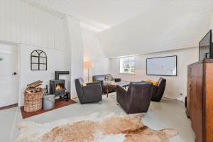 a living room with a couch and a fireplace at AE304-Aeroskobing-Stokkeby-Hovedgade-18 in Ærøskøbing
