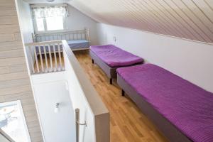 a room with two beds with purple cushions at Holiday Linnunlahti in Joensuu +25 photos