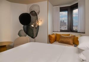 a bedroom with a bed and a couch at Hyatt Centric Reims in Reims