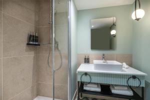 a bathroom with a sink and a shower at Hyatt Centric Reims in Reims +40 photos