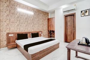a bedroom with a large bed and a table at Collection O Palwal-Aligarh Crossway Formerly Hotel Kadamb in Palwal