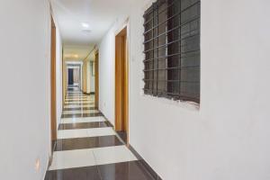 a hallway with a black and white tile floor at Super Collection O Manjari - Mundhwa Road Formerly 7 Treats in Mundhwa +25 photos