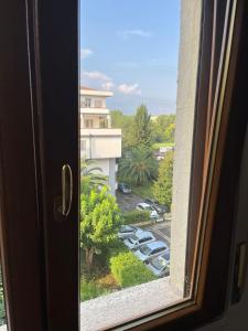 a window with a view of a parking lot at Manuel House in Pisa in Pisa +20 photos