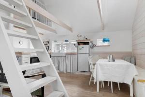 a kitchen and dining room with a table and a refrigerator at 20331-Samso-Vestergade-37 in Kolby