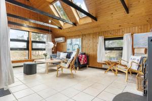 a living room with a couch and chairs and windows at TV1575-Skagen-Solbakken-23 in Skagen