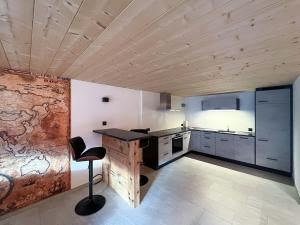 a kitchen with a table and a chair in a room at Lake View Chalet Mis in Iseltwald