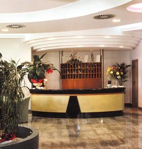 a lobby with a reception desk and some plants at Villa Dei Romanzi in Tortoreto Lido