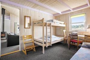 a room with two bunk beds and a table at TV1383-Hirtshals-Klitmarken-14 in Hirtshals