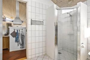 a bathroom with a shower with a glass door at TV1383-Hirtshals-Klitmarken-14 in Hirtshals +19 photos