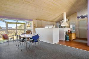 a kitchen and dining room with a table and chairs at TV1383-Hirtshals-Klitmarken-14 in Hirtshals