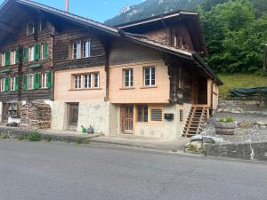 an old wooden house on the side of a road at Lake View Chalet Mis in Iseltwald