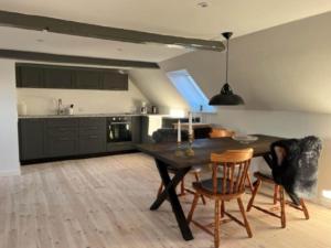 a kitchen with a table and chairs in a room at AE231-Marstal-Ny-Mollergade-2-A in Marstal