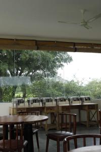 a room with tables and chairs and a large window at The Jawai Vanya Bagh Resort By Lavender Hotels in Fālna